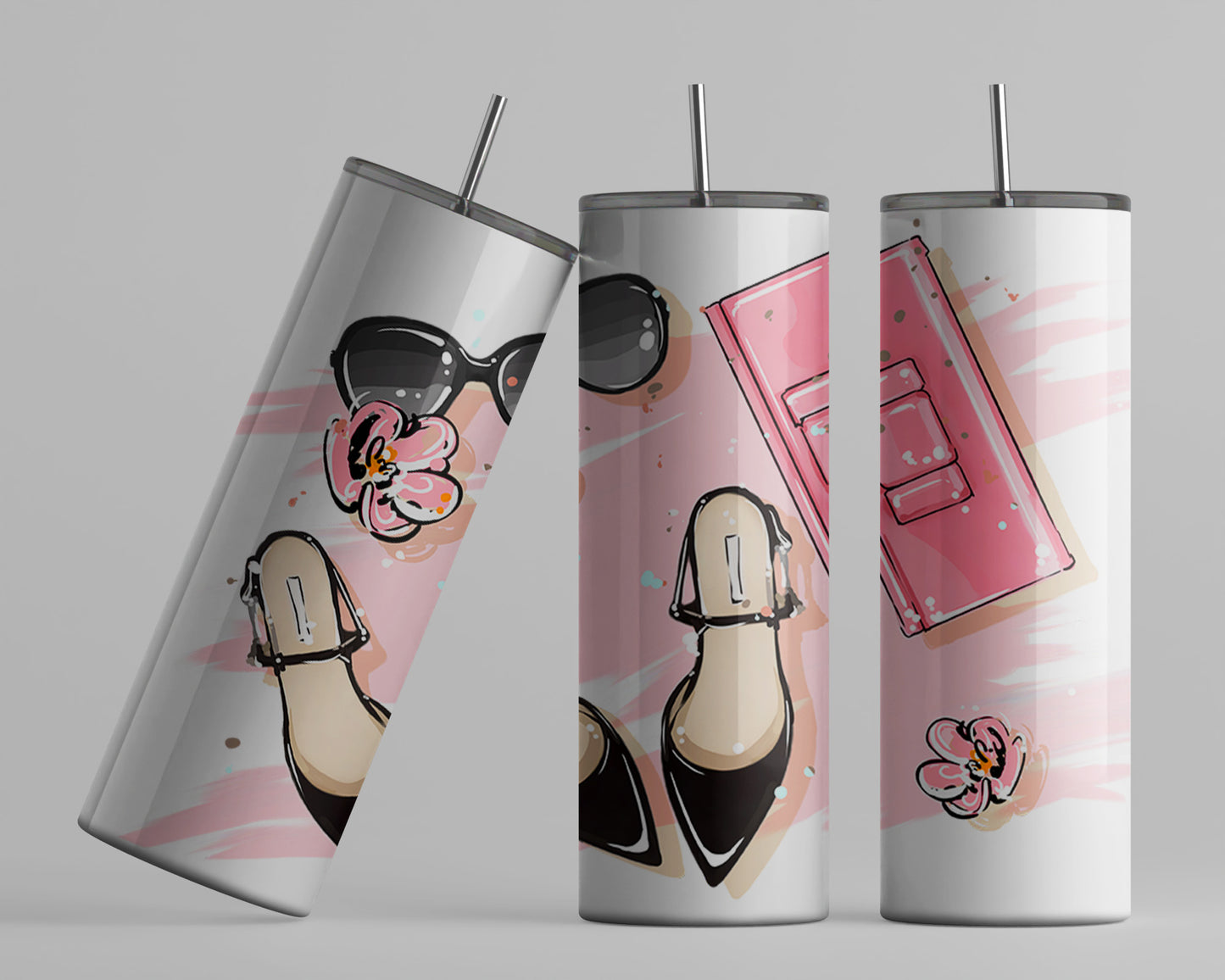 This is a white 20oz tumbler with a pink brush stroke background, on top of the background we have a pair of black ladies dress shoes, sunglasses and pink clutch with two pink flowers . The tumbler has a stainless straw.