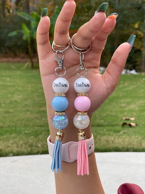 we have a 3 bead 2rhinestone spacer beads, keyring with the first bead reading BEST FRIEND, with once solid color bead and one holographic clear bead with the rhinestone spacer between each bead, the keychain is finished with a  2 and a half inch gold cap tassel. This key ring measures 6 and half inches