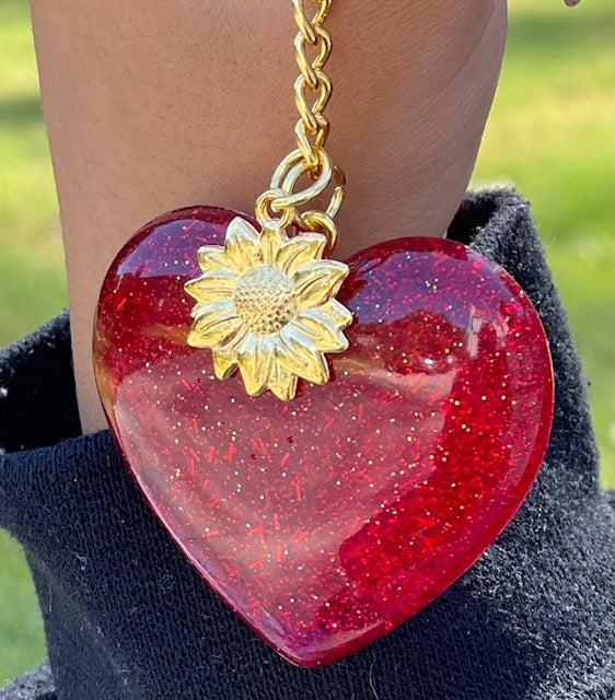 This a red heart with  silver glitter with gold sunflower dangle.